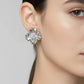 close up of a silver plated floral earring with a zirconia gem centre